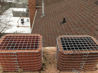 A person installing a squirrel deterrent system